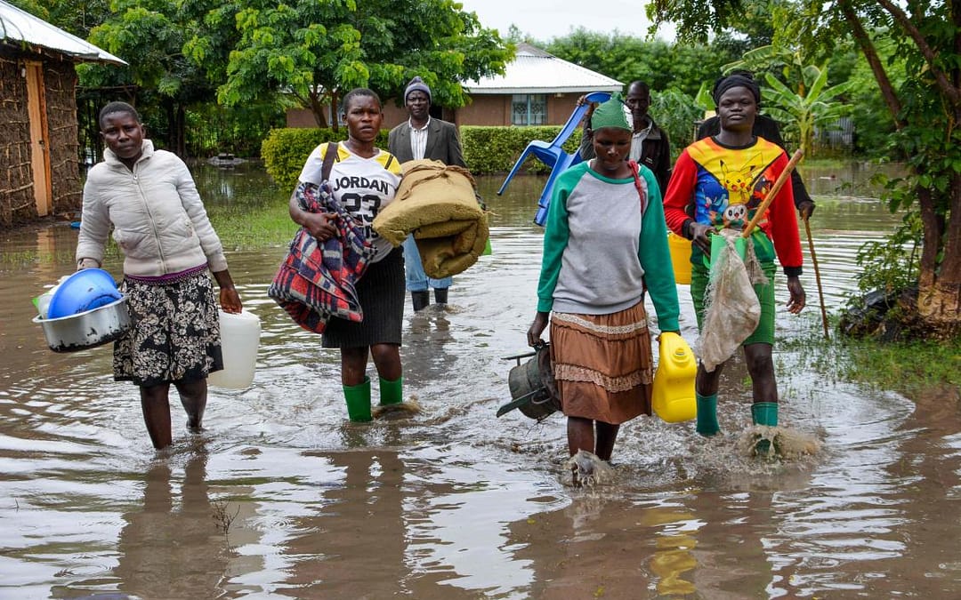 People leave their homes due to flooding from parts of Lake Kyoga